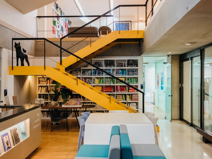 Lee Young-hye sitting in her design office surrounded by books and magazines
