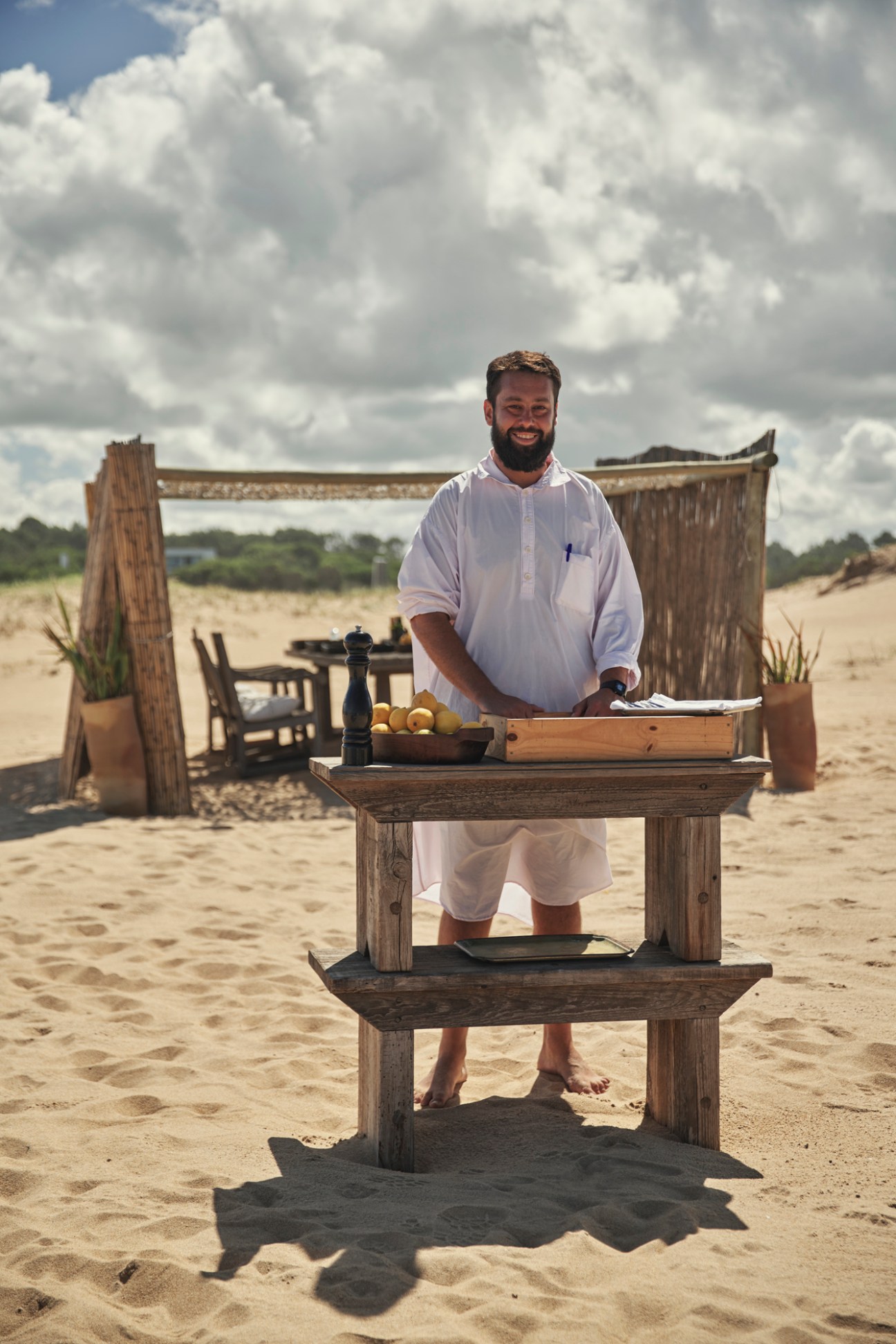 Barefoot waiter Carlos serving lunch at Chiringuito beach restaurant in José Ignacio, Uruguay.