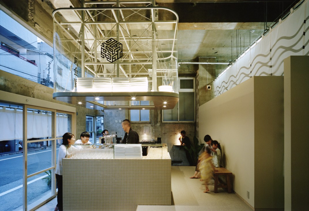 Front reception area with craft beer bar featuring bottles and taps available to the community