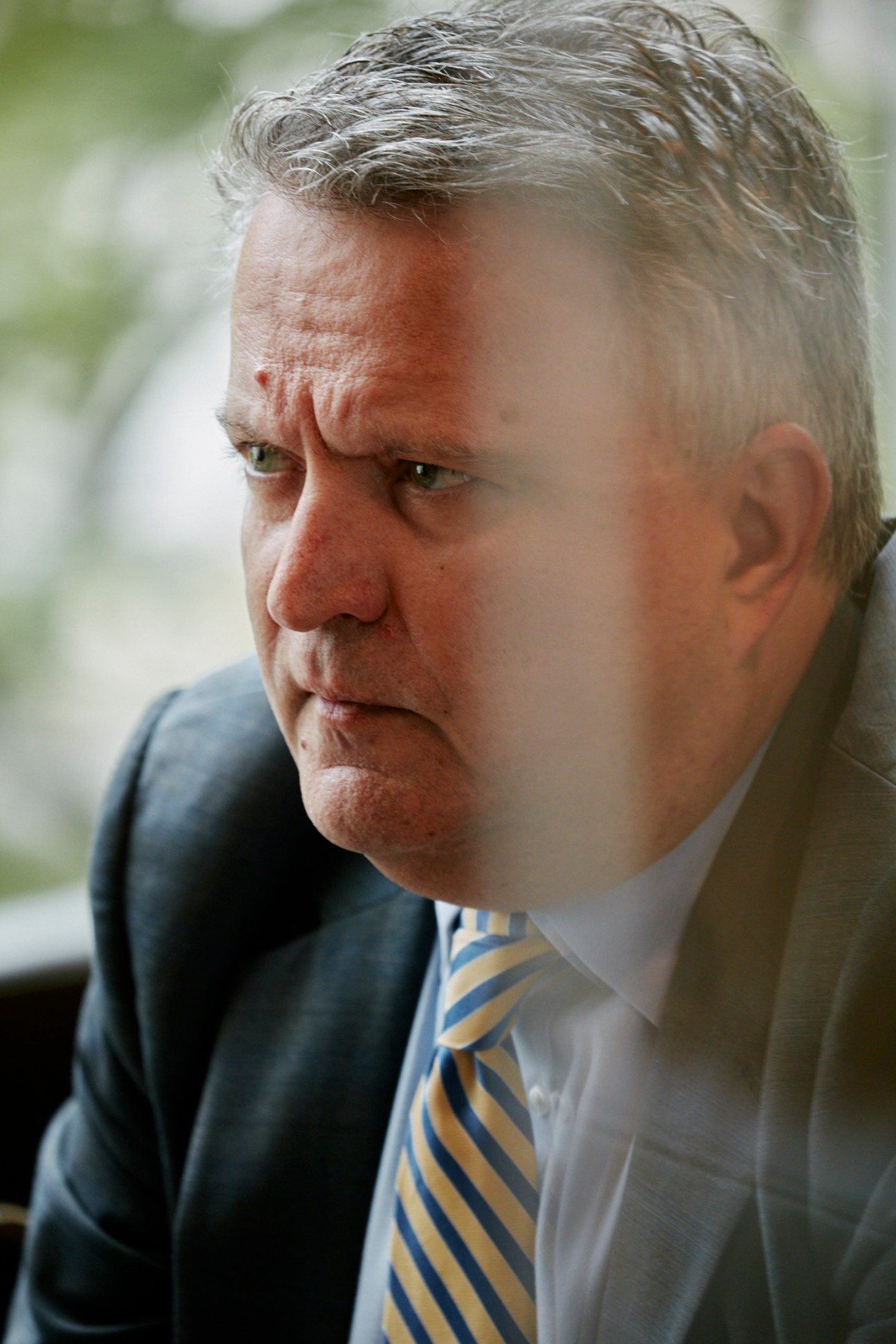 Portrait of Ukraine's UN Ambassador Sergiy Kyslytsya in a dark suit and striped tie.