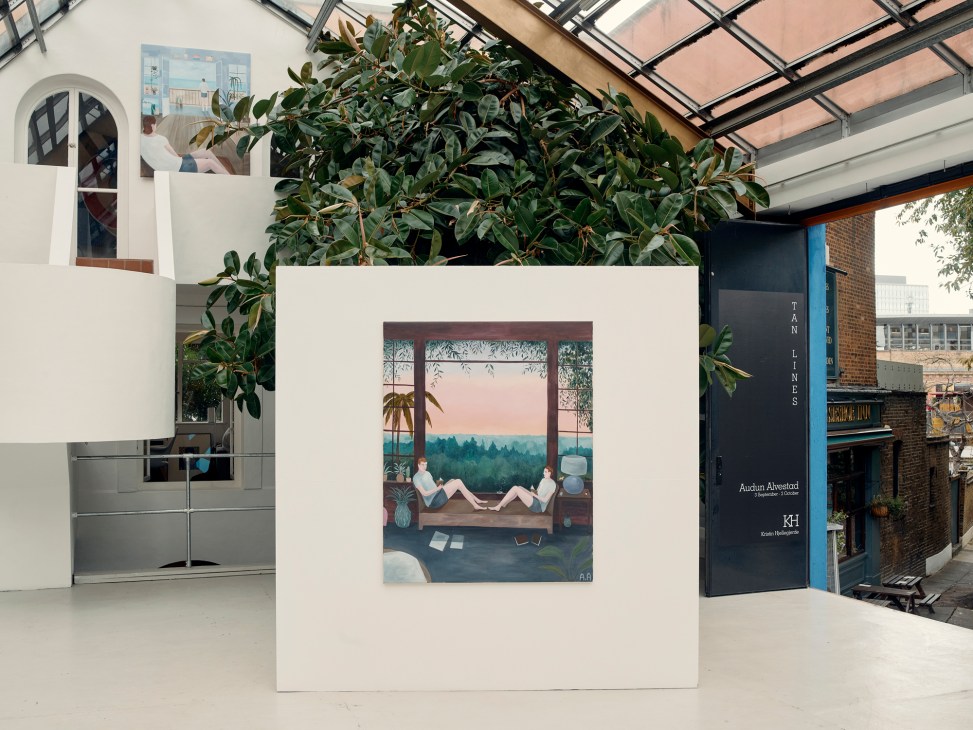 Interior of Kristin Hjellegjerde gallery showing artwork displayed on white wall with plants and skylight above.