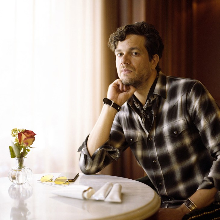 Kristoffer Vural, founder of Selahatin toothpaste brand, sits at a table in contemplative pose.