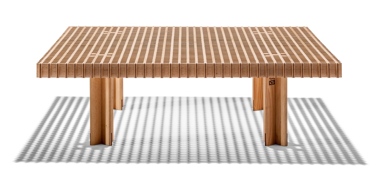 Wooden table with slatted top showing exposed joinery construction and trestle base legs