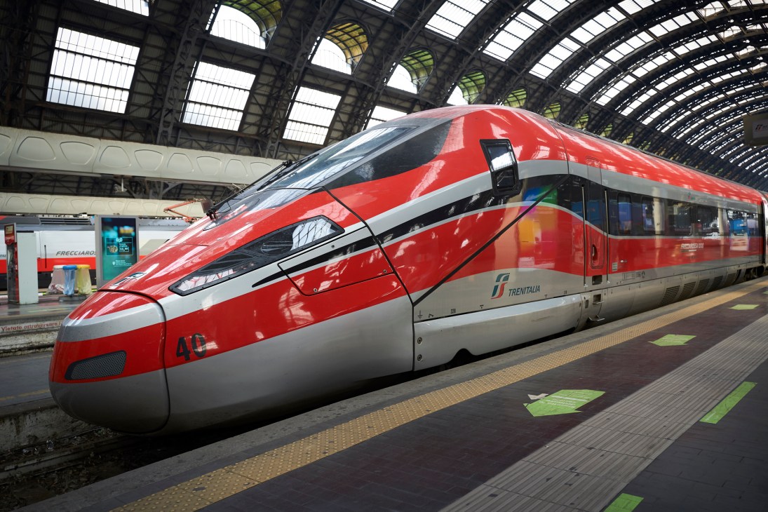Red and silver Frecciarossa high-speed train at Milano Centrale station platform