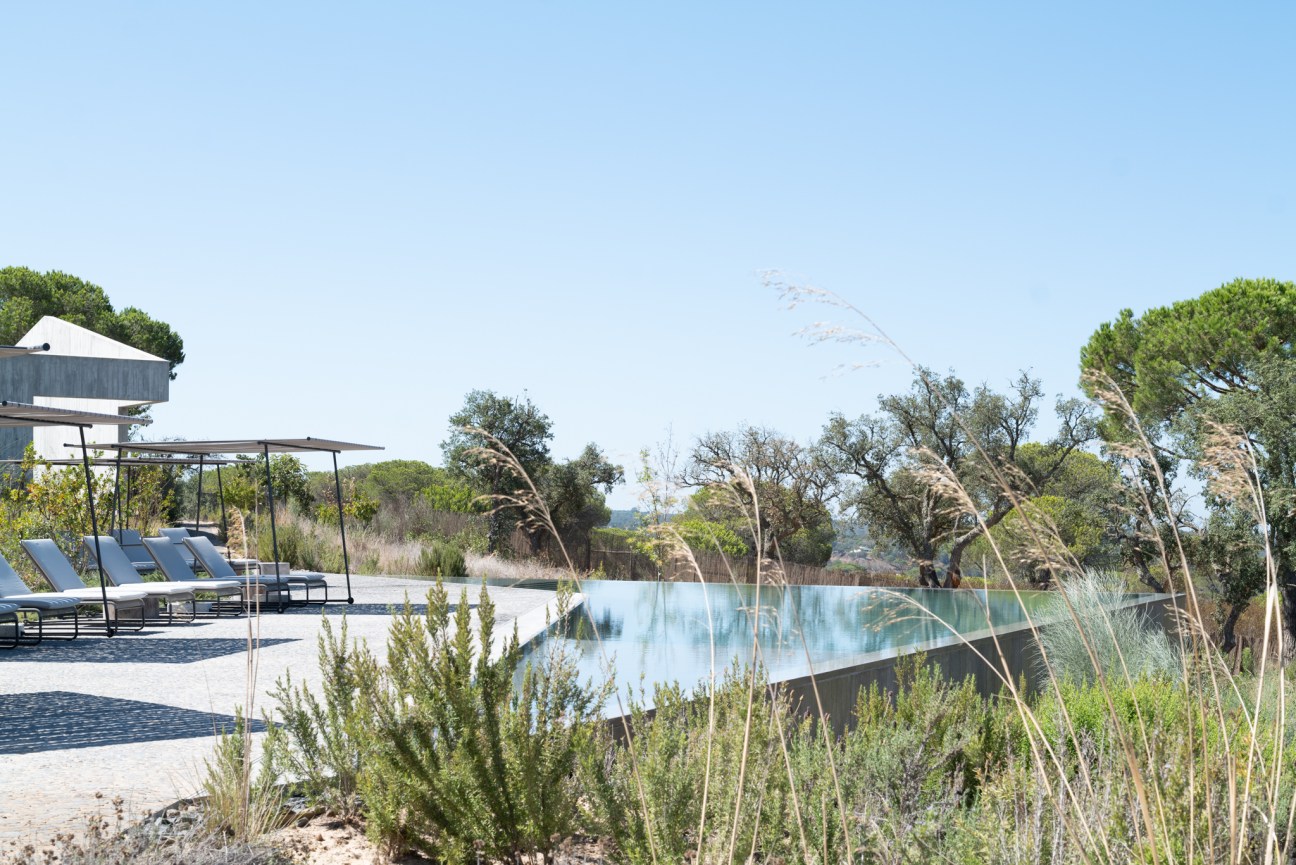 Central swimming pool with villas arranged around it overlooking the Atlantic