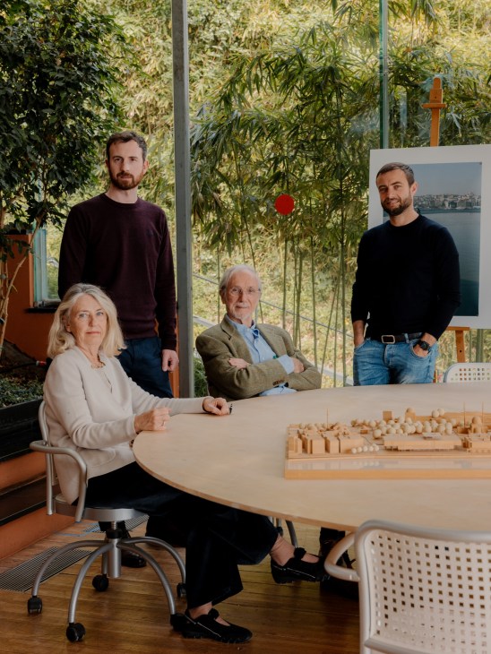 Four members of the Istanbul Modern design team standing together in the studio, smiling at camera