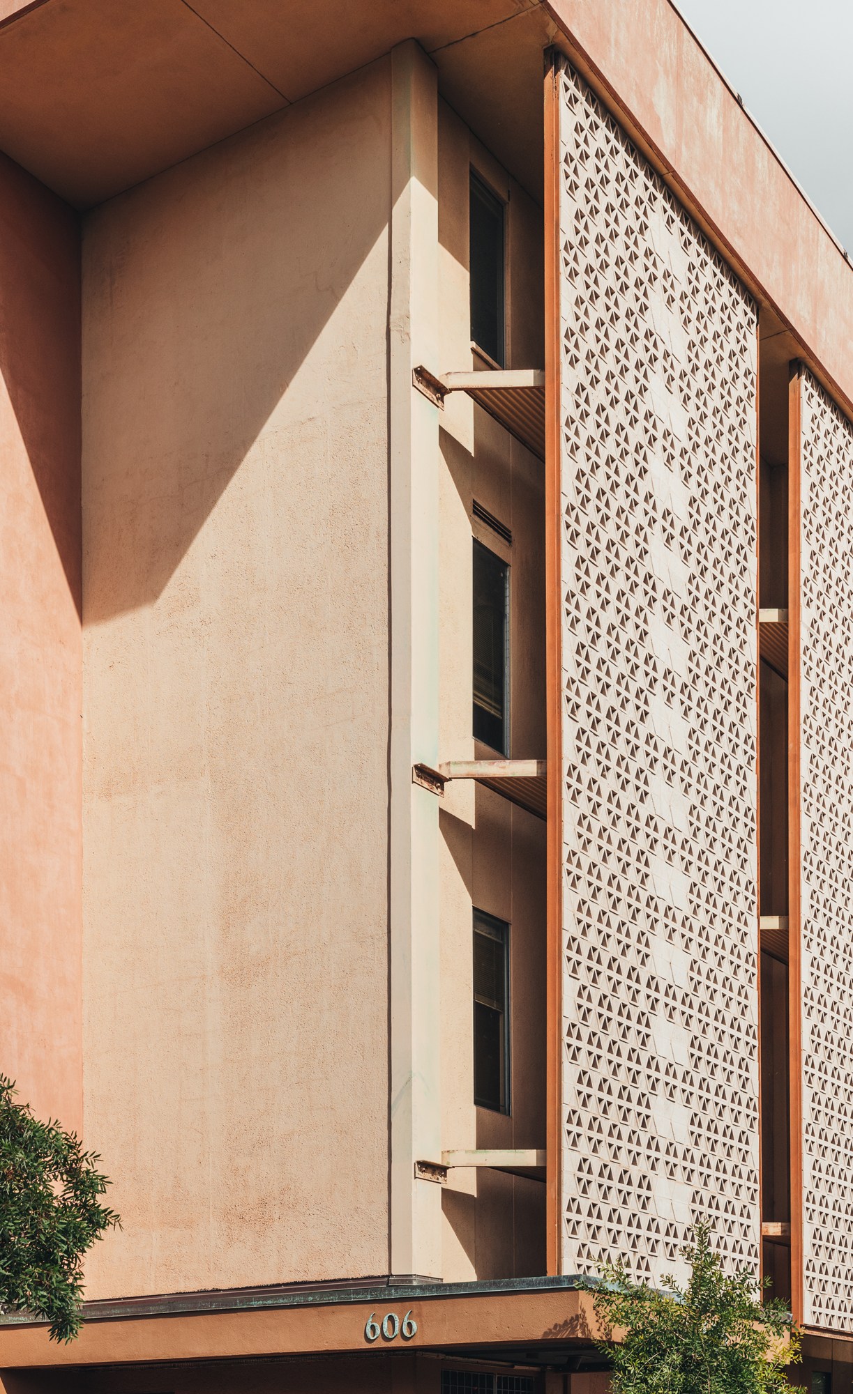 Interior view showing how perforated walls create ventilation and dappled lighting in Hawaiian modernist architecture