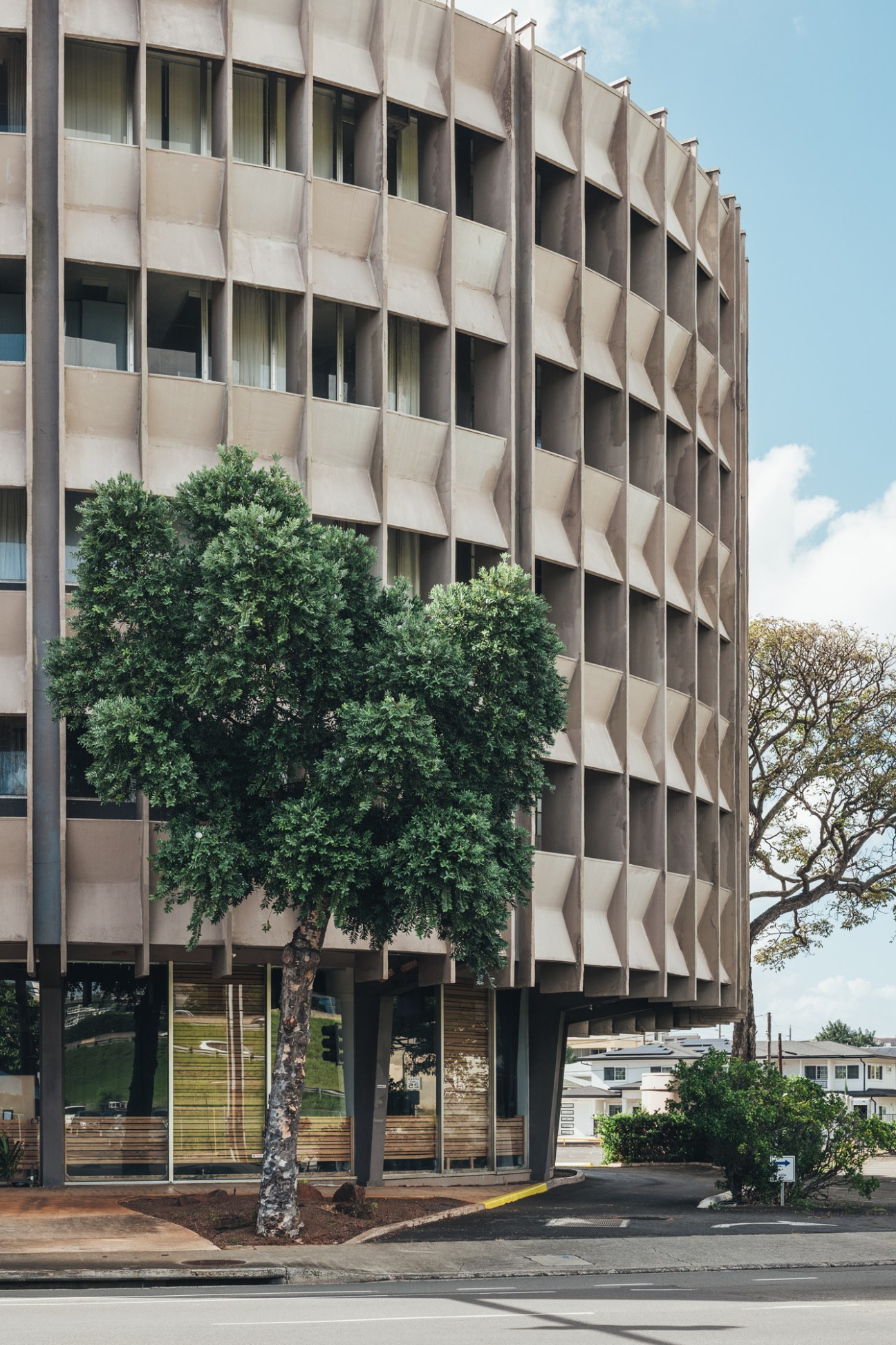Mid-century apartment building in Honolulu featuring latticed screens and strategic window openings for natural cooling