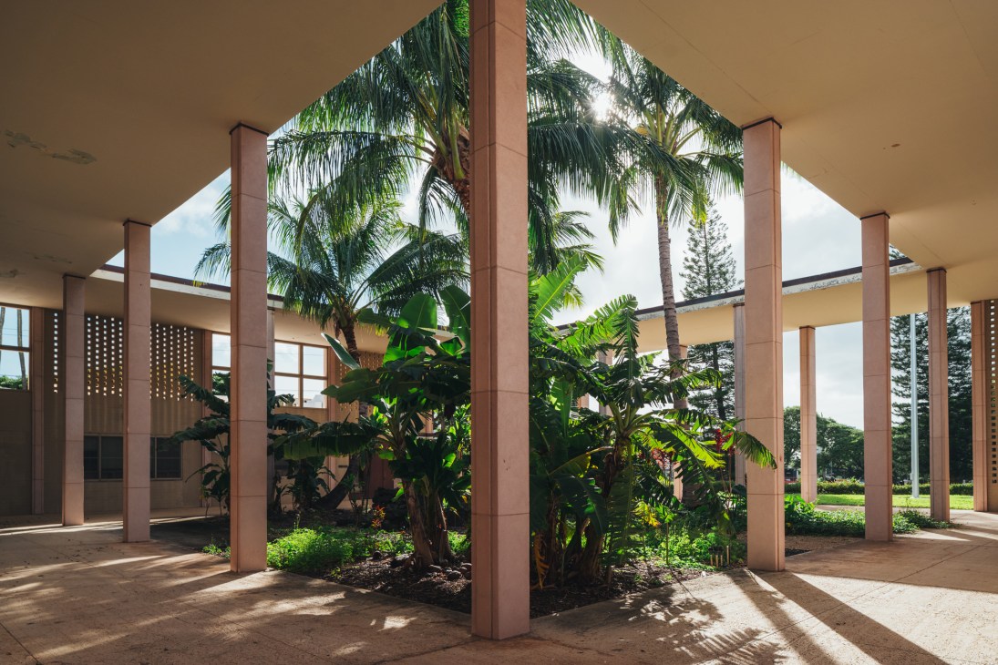 Wide view of IM Pei's University of Hawaii building showing the elevated main structure with shaded courtyard space below