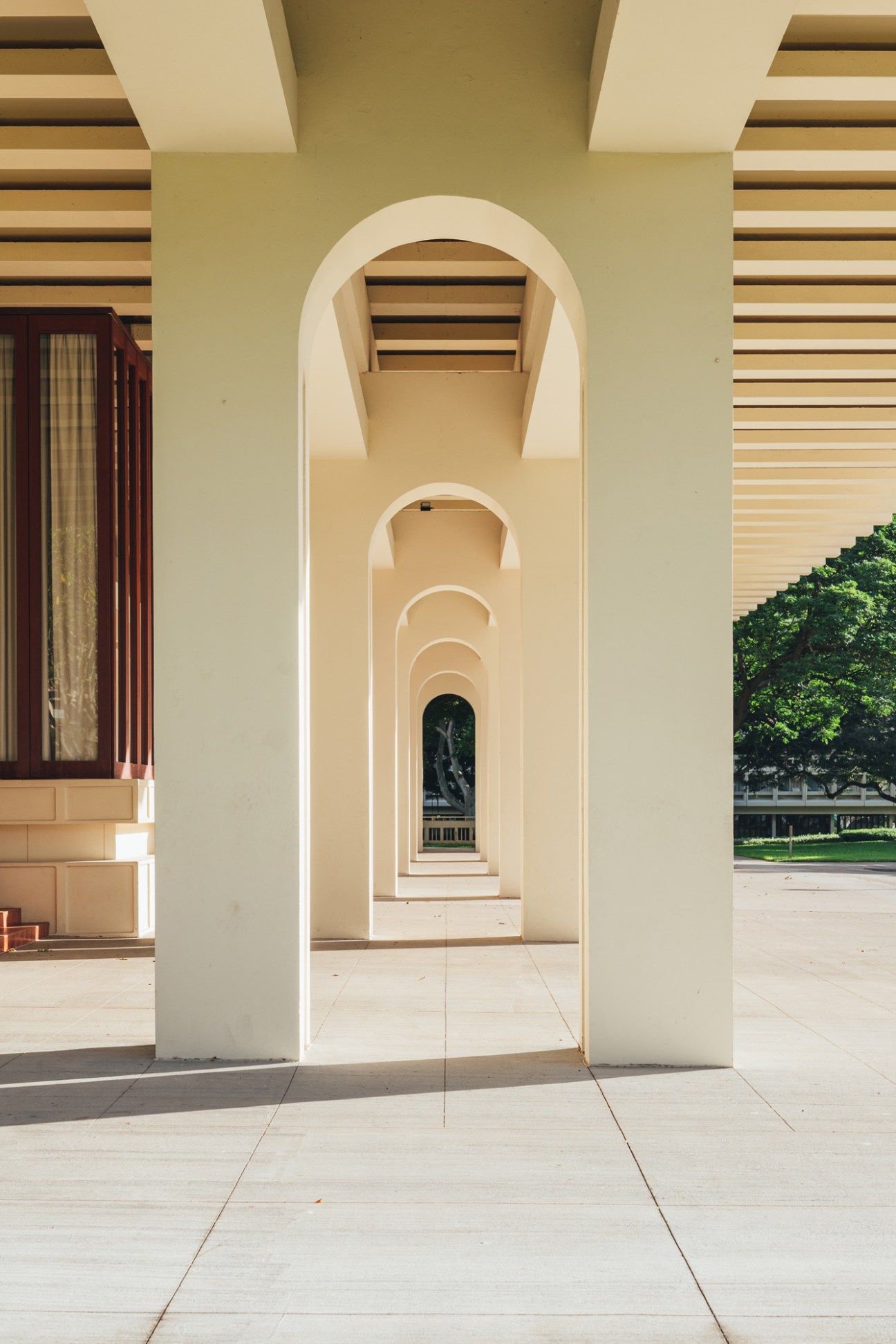 Detail of concrete pillar and cantilevered structure showing how the building creates shade through elevated design