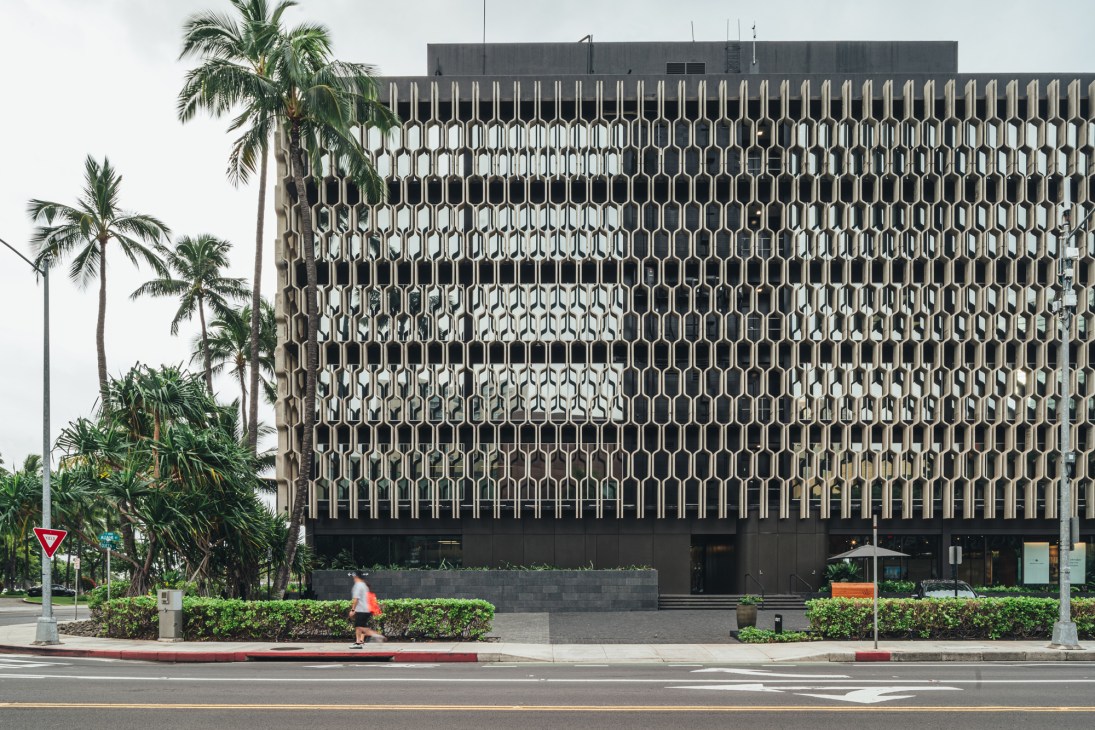 Honolulu building with perforated concrete screen wall creating geometric patterns while allowing air circulation