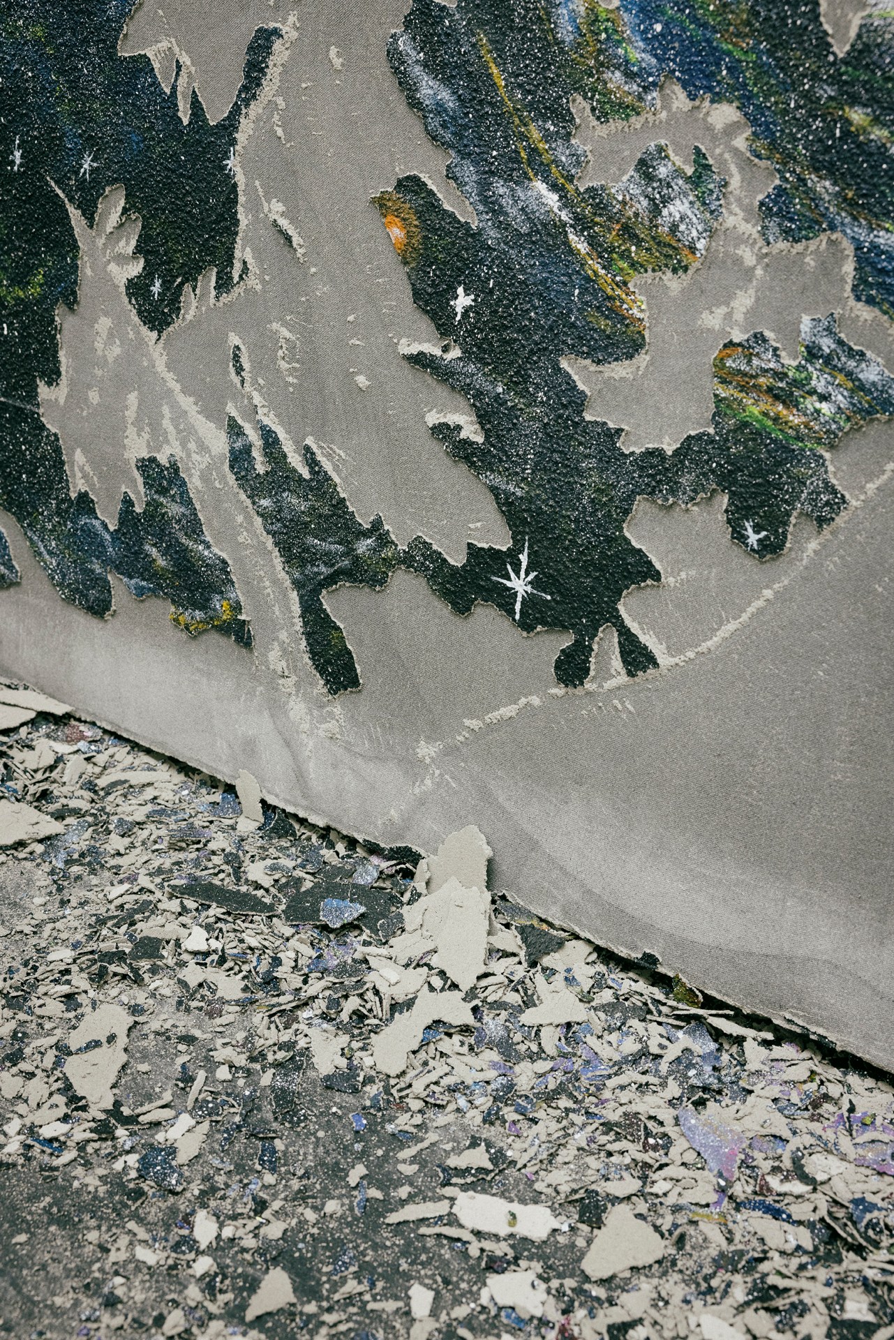 Close-up of hands working with colorful paint and art materials on a surface