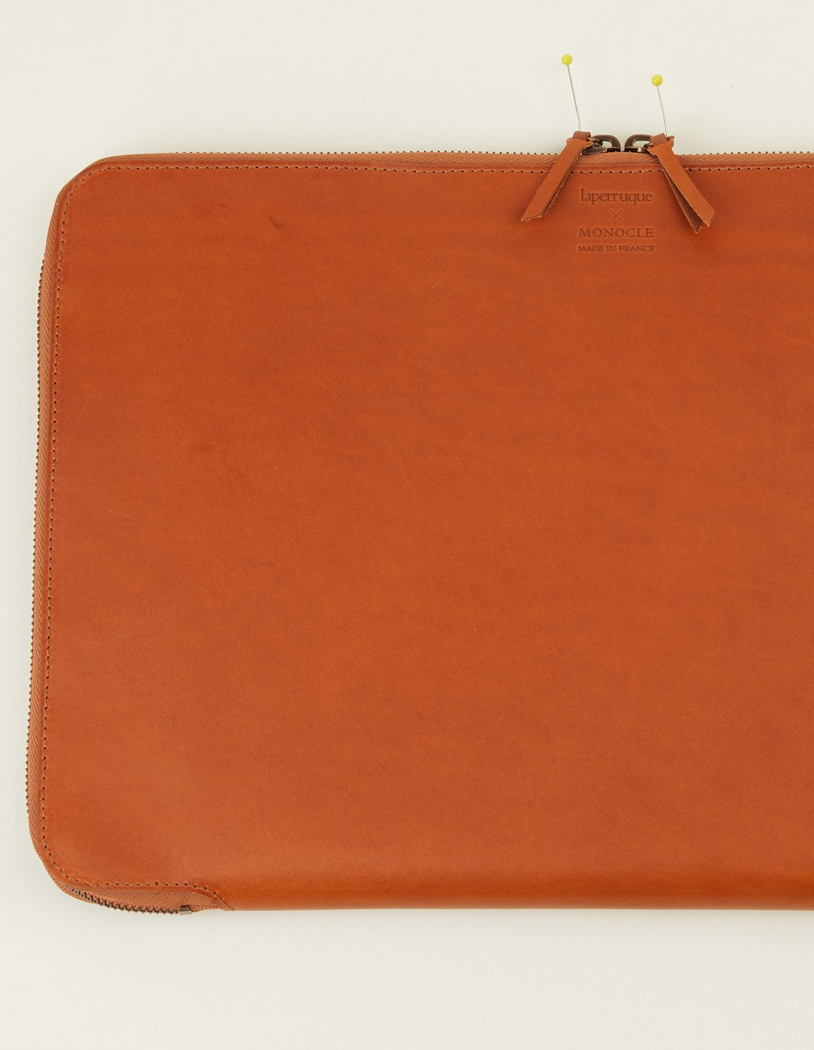 Laperruque x Monocle leather laptop case in tan with yellow pin details.