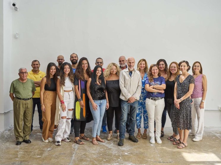 Group of people posing together for a photo smiling