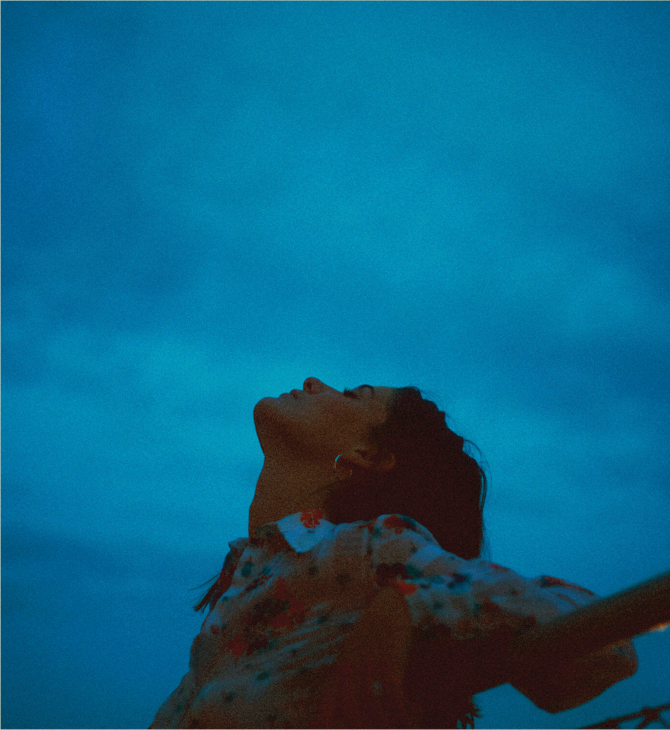 Album cover for Apart by Léon showing a person lying back against a bright blue background