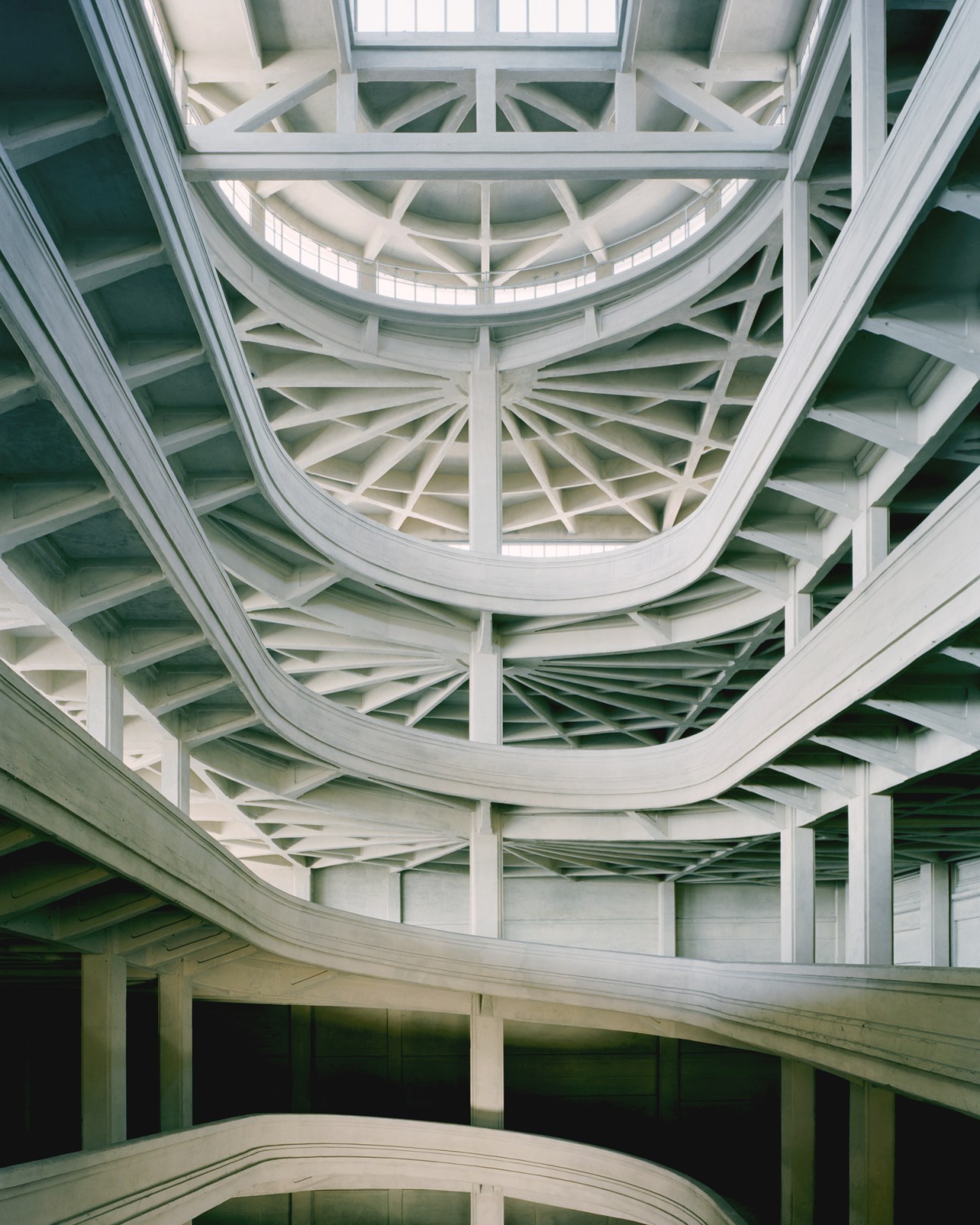 Interior view of curved concrete ceiling with radiating structural elements at Fiat Lingotto factory in Turin