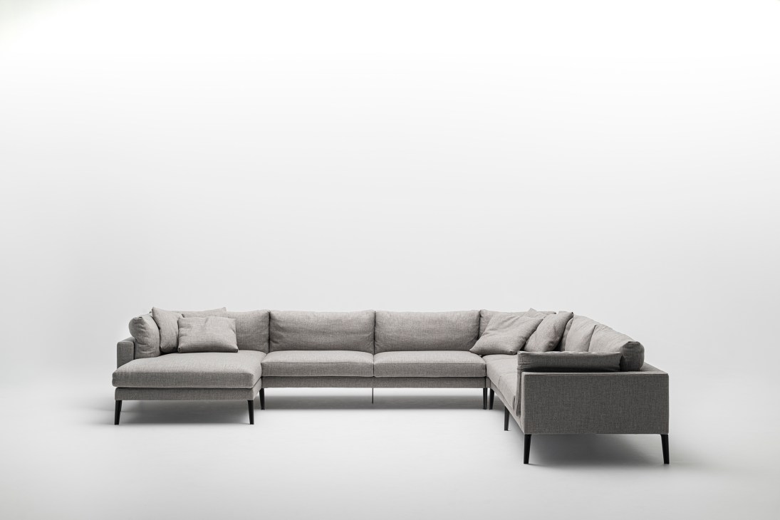 Floyd-Hi 2 sectional sofa by Living Divani in grey upholstery with cushions against white background.