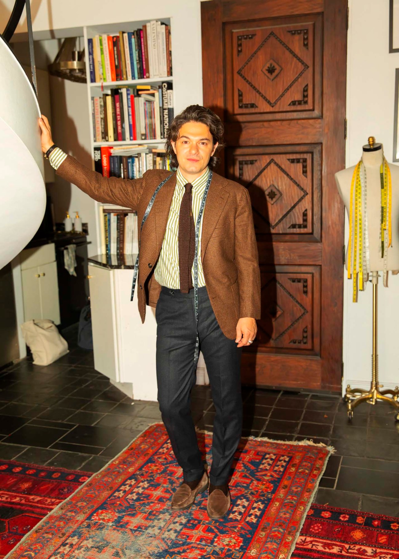 Jake Mueser, founder of J Mueser tailoring house, standing in his West Village atelier