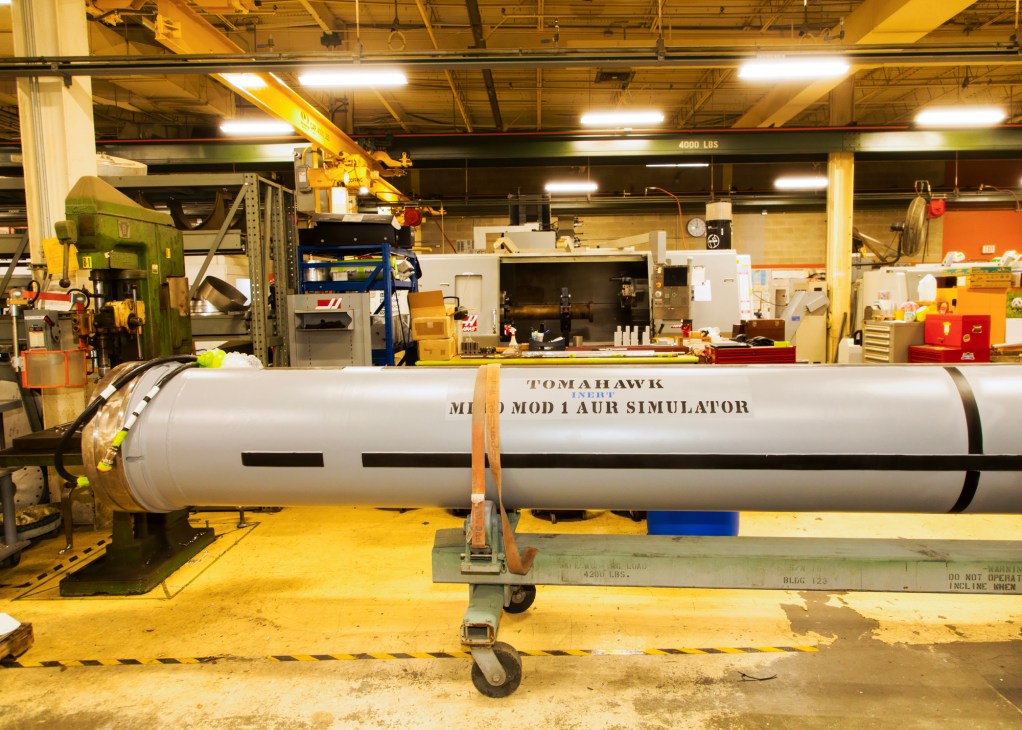 Large white cylindrical Tomahawk missile simulator in an industrial fabrication facility