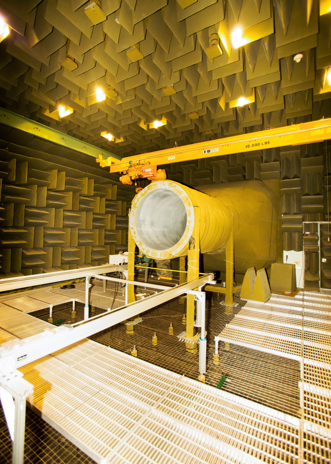 Large cylindrical chamber with acoustic foam panels covering walls and ceiling in Naval Undersea Warfare Centre