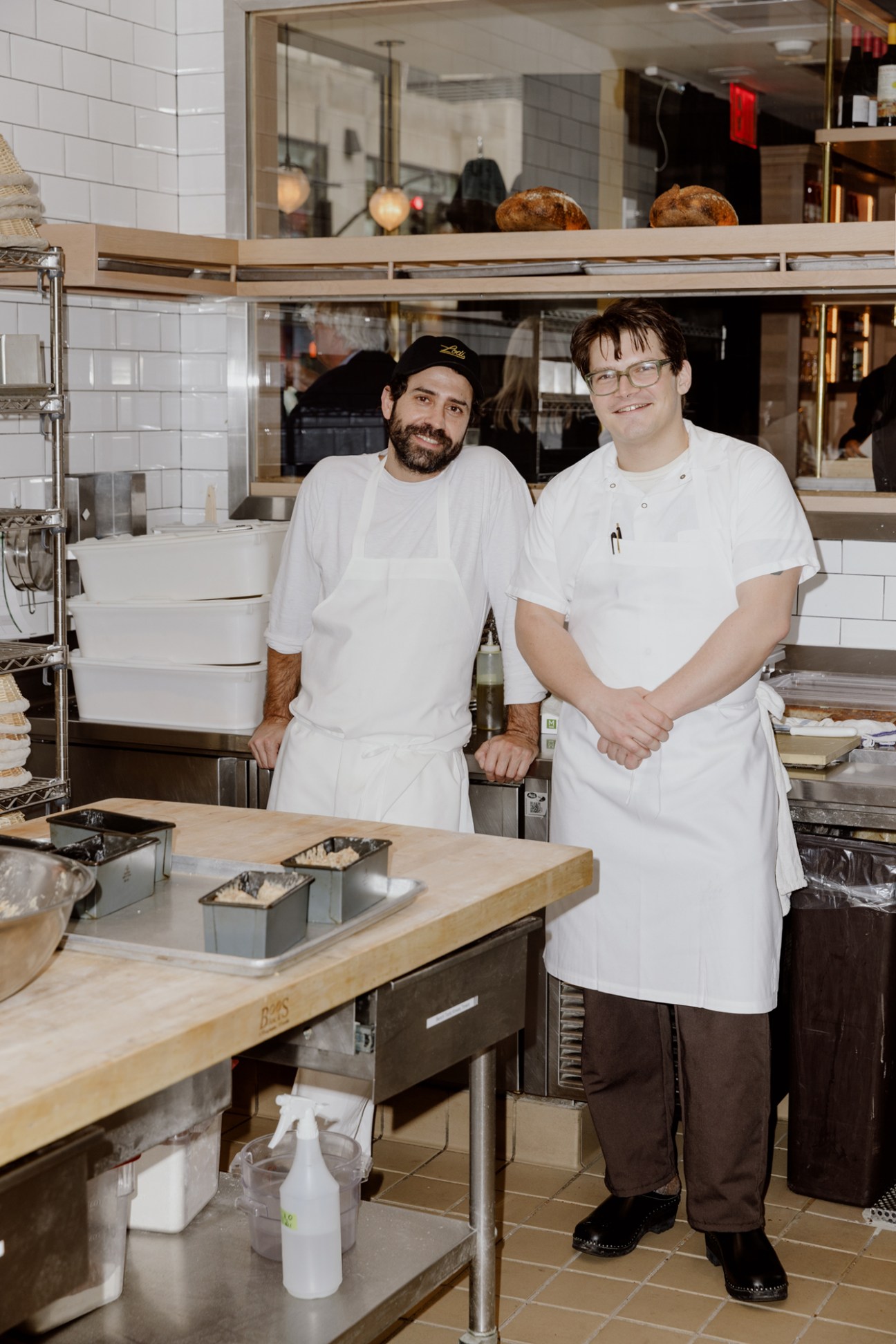 Ignacio Mattos and chef de cuisine Maxime Pradié standing in restaurant kitchen wearing white chef coats
