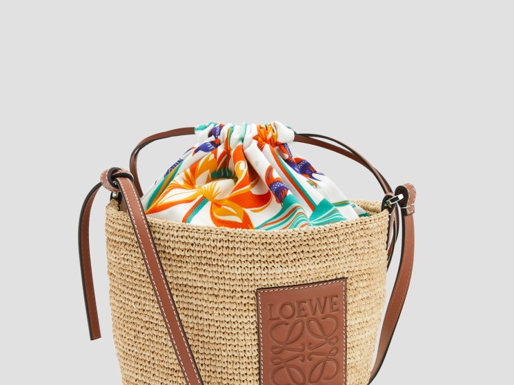 Loewe Paula's Ibiza woven bag with colorful striped fabric drawstring closure and brown leather details.