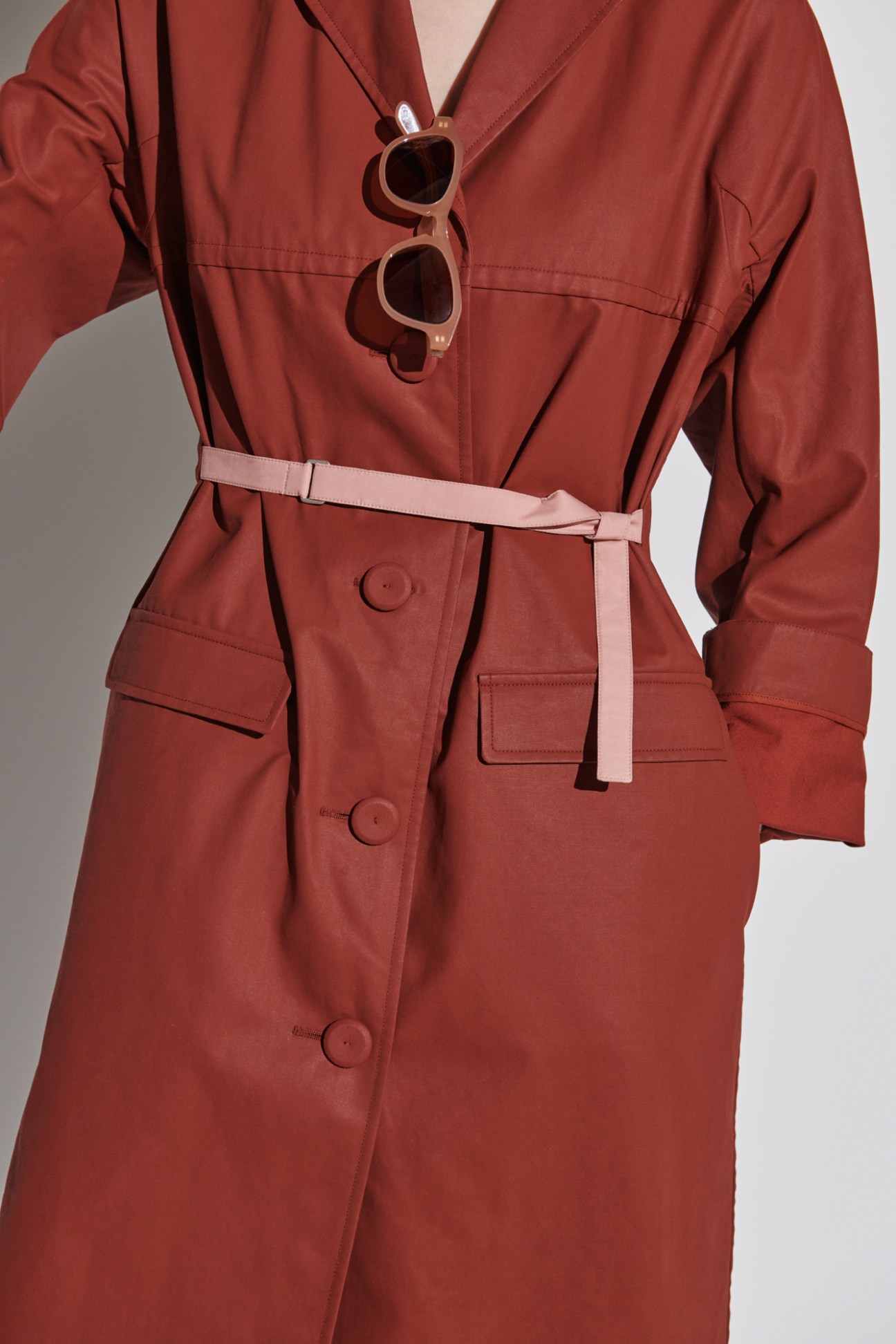 Woman wearing red Jil Sander dress with pink belt and Article One sunglasses