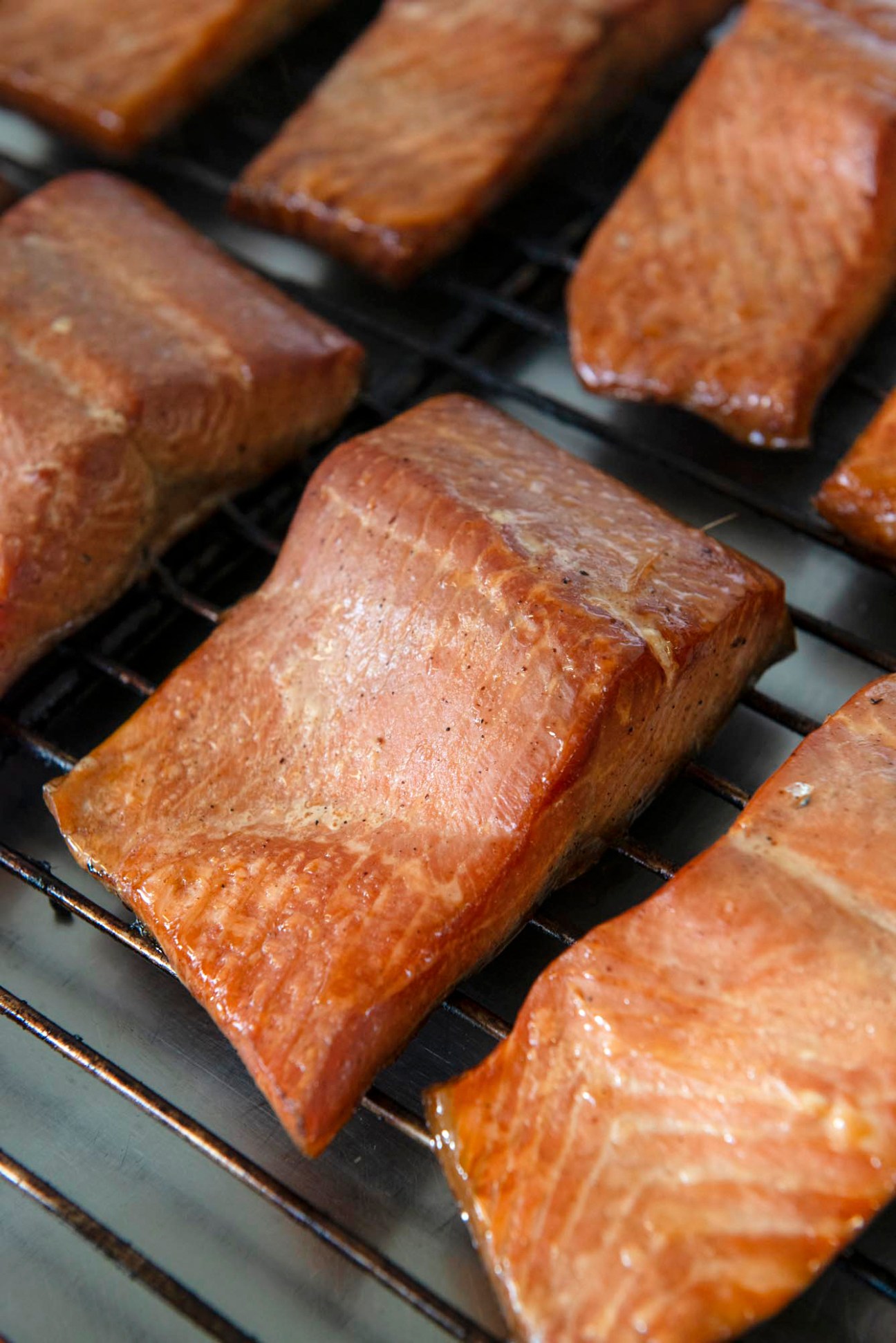 Fresh ocean trout fillets on a grill with golden-brown cooked surface and grill marks