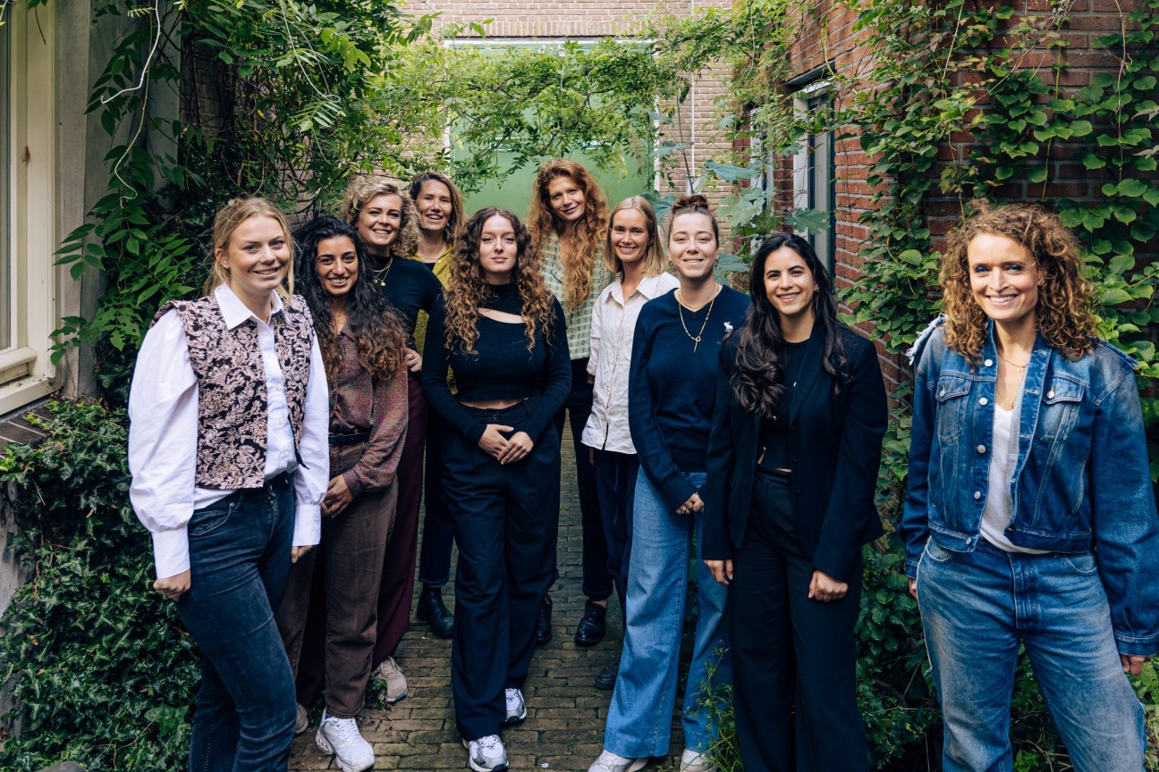 Group photo of Studio Modijefsky's all-female team working in their canal-side office