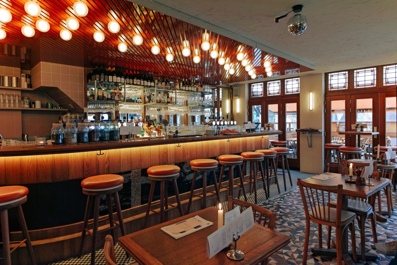 Modern bar interior at Ami restaurant showing clean lines, contemporary lighting and seating