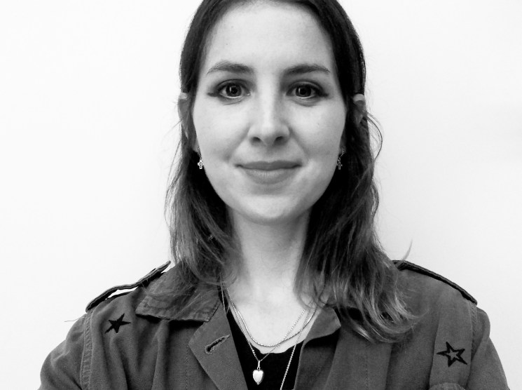 Black and white headshot of a young woman smiling.