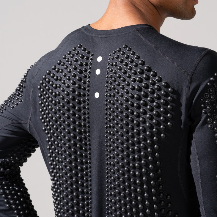 Close-up view of black athletic wear with strategically placed spherical weights across the garment