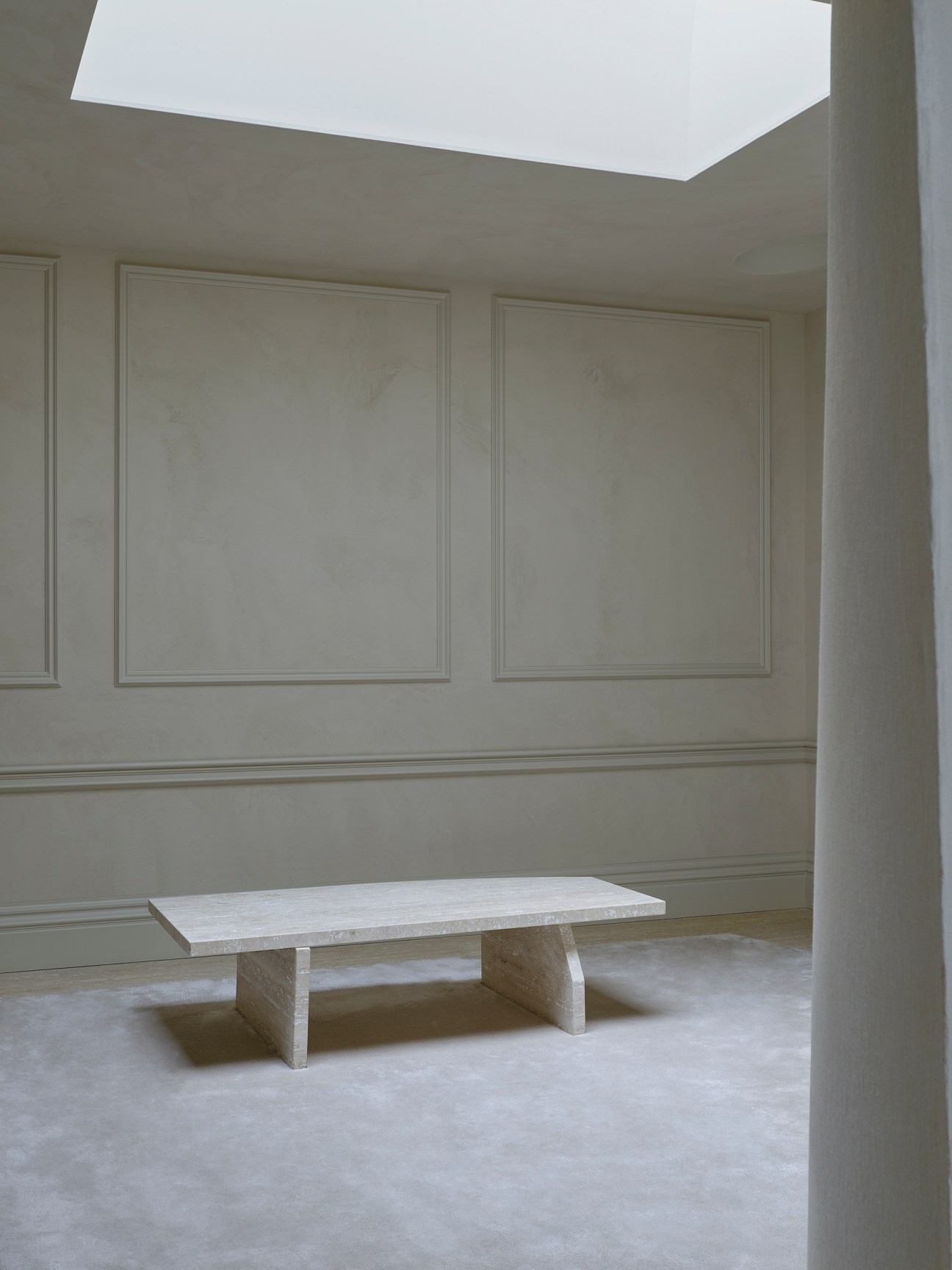 Interior view of Maison Margiela store showing sculpted gypsum walls with textile-like draping patterns