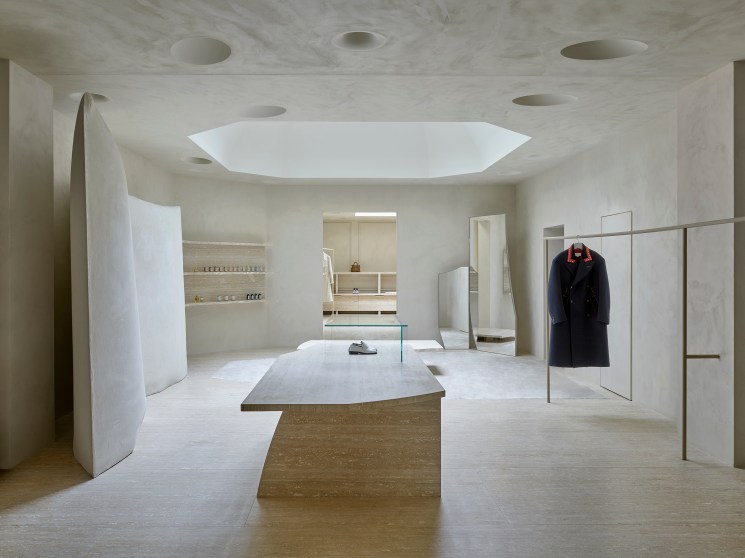 Interior of Maison Margiela store showing sculpted white gypsum walls and minimalist retail space