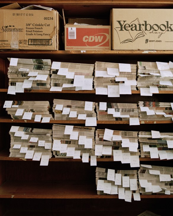 Stacks of recent Enterprise newspaper issues organized and tagged for archival storage