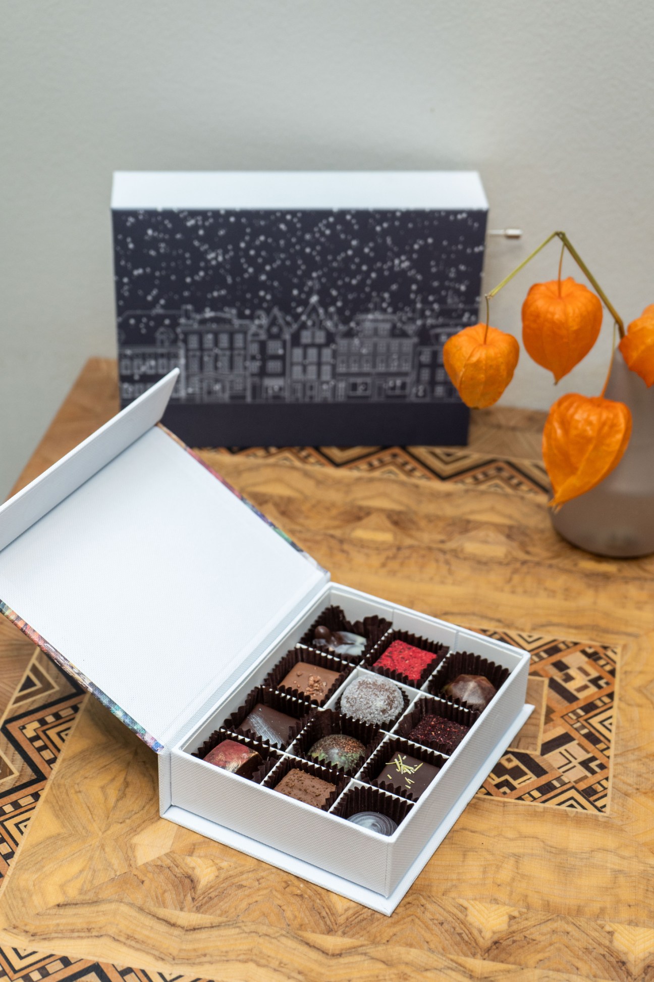 Chocolala artisanal chocolates in white gift box with winter scene packaging and physalis decorations
