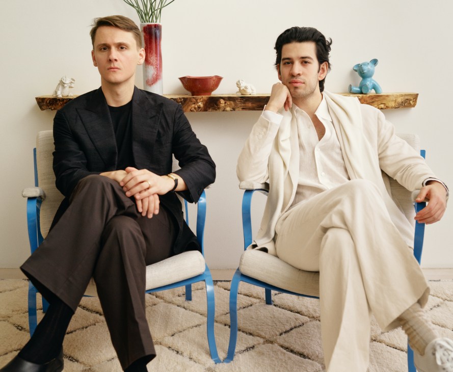 Dag Granath (on left) and Saman Amel sitting in chairs in a modern interior space