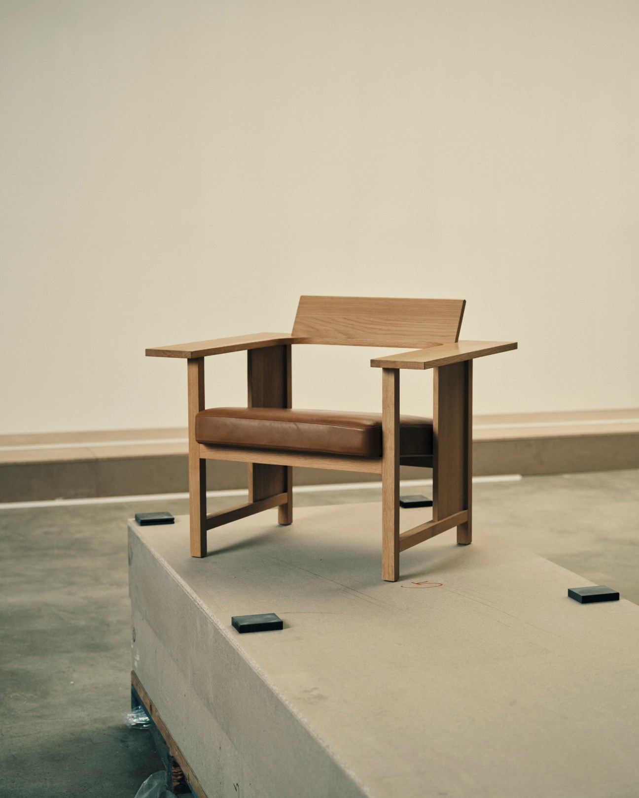 MC 10 Clerici chair designed by Konstantin Grcic displayed on concrete platform in minimalist setting