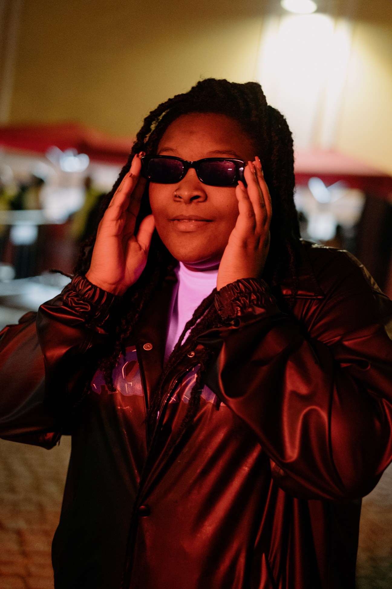 DJ Nídia wearing sunglasses and red jacket at Sónar festival in Lisbon.
