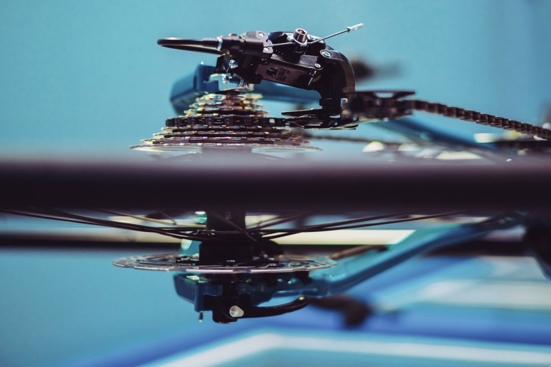 Close-up view of bicycle chain and gears showing mechanical components and manufacturing detail