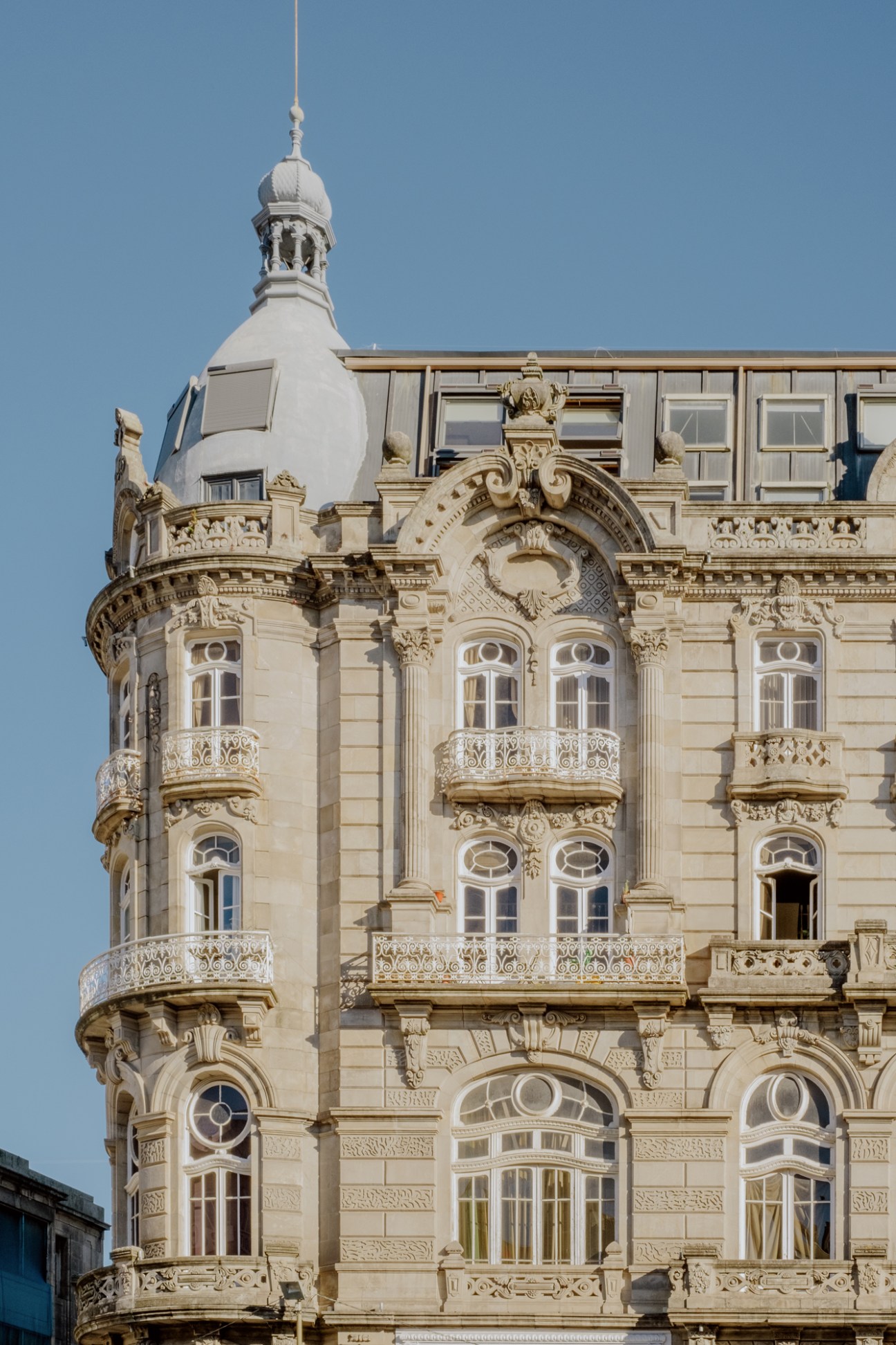 Ornate historic building facade with decorative stone balconies, carved details, and baroque architectural elements