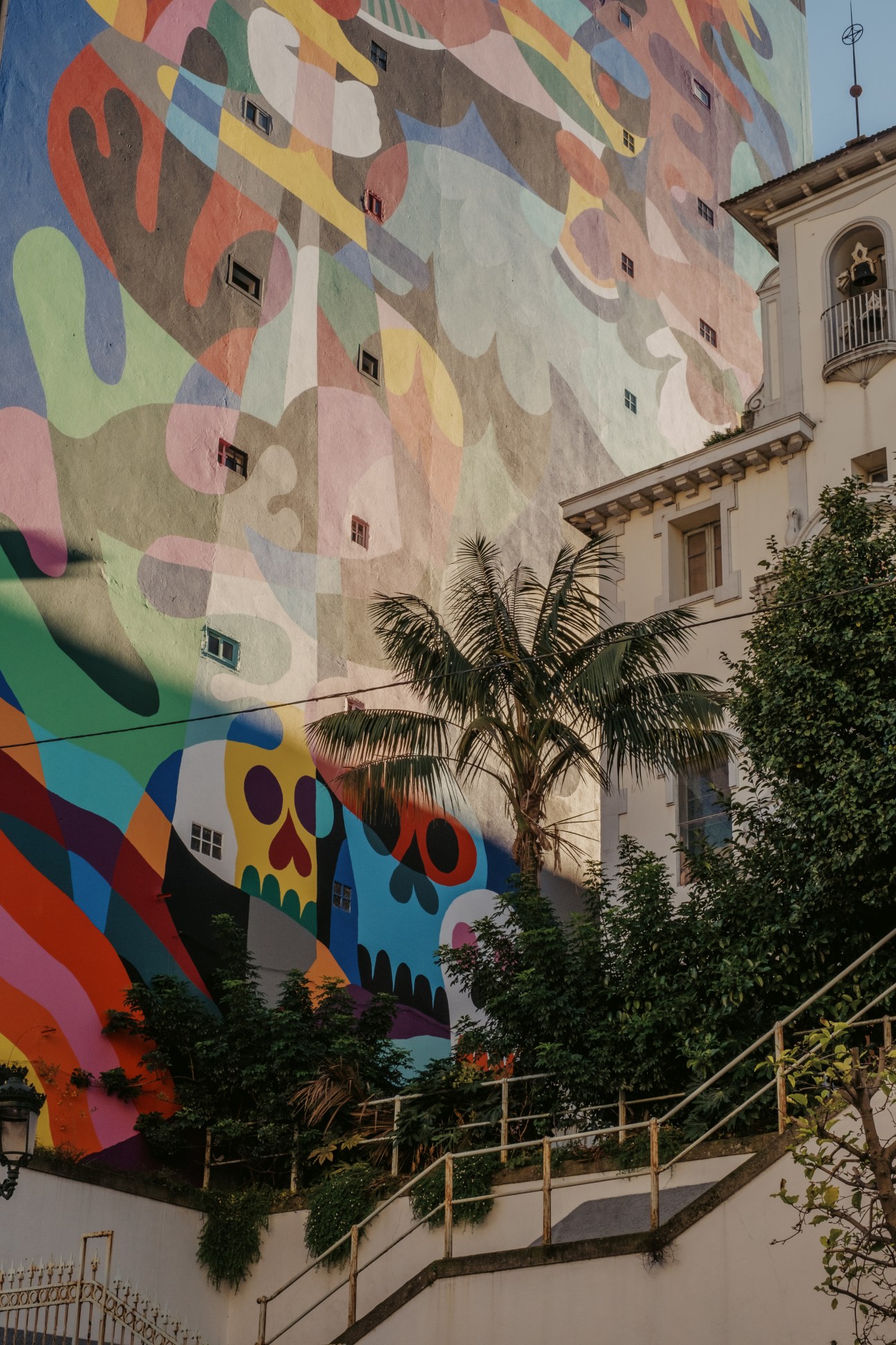 Vibrant abstract street art mural on building wall with colorful organic shapes and patterns