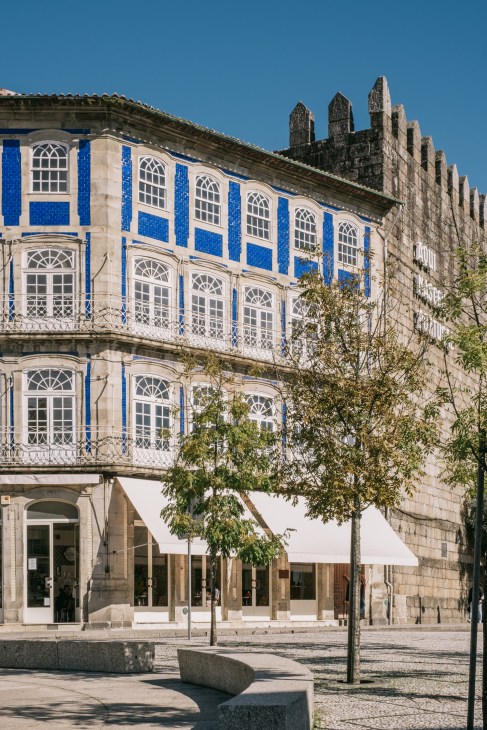 Historic stone buildings with traditional architecture in Guimarães, Portugal's city center.