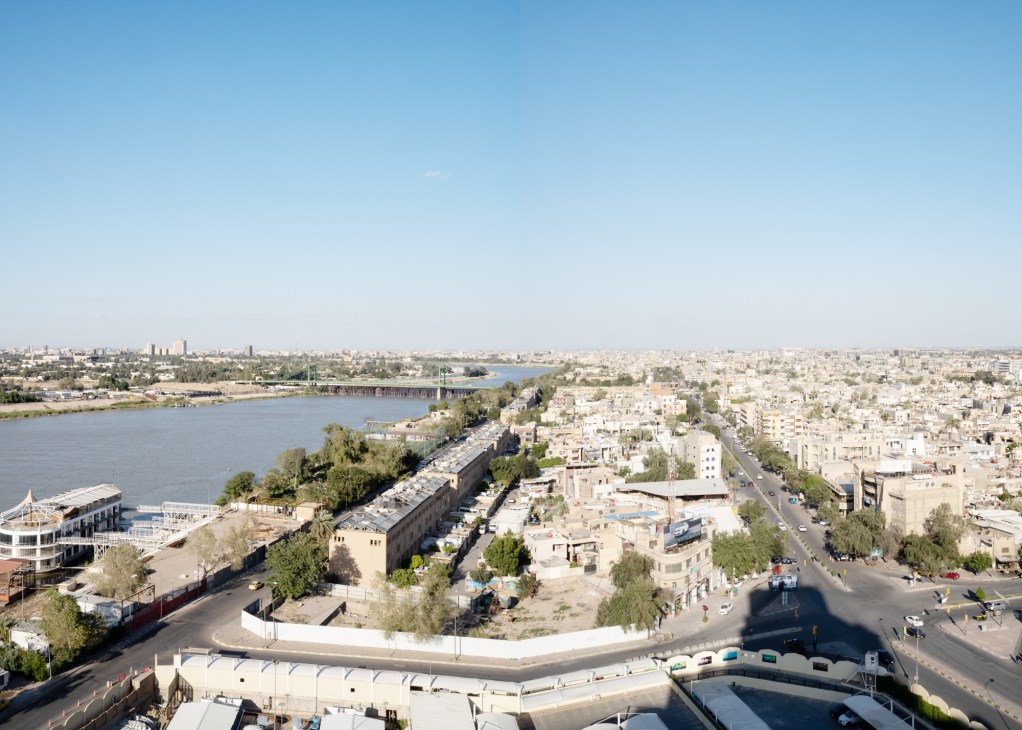 Aerial view of Baghdad showing the Tigris River winding through the city with modern buildings and historic structures