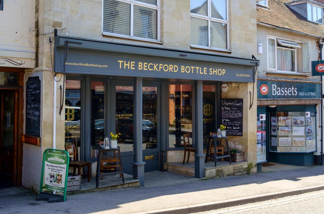 Wine shop interior with extensive bottle selection and wooden shelving displays