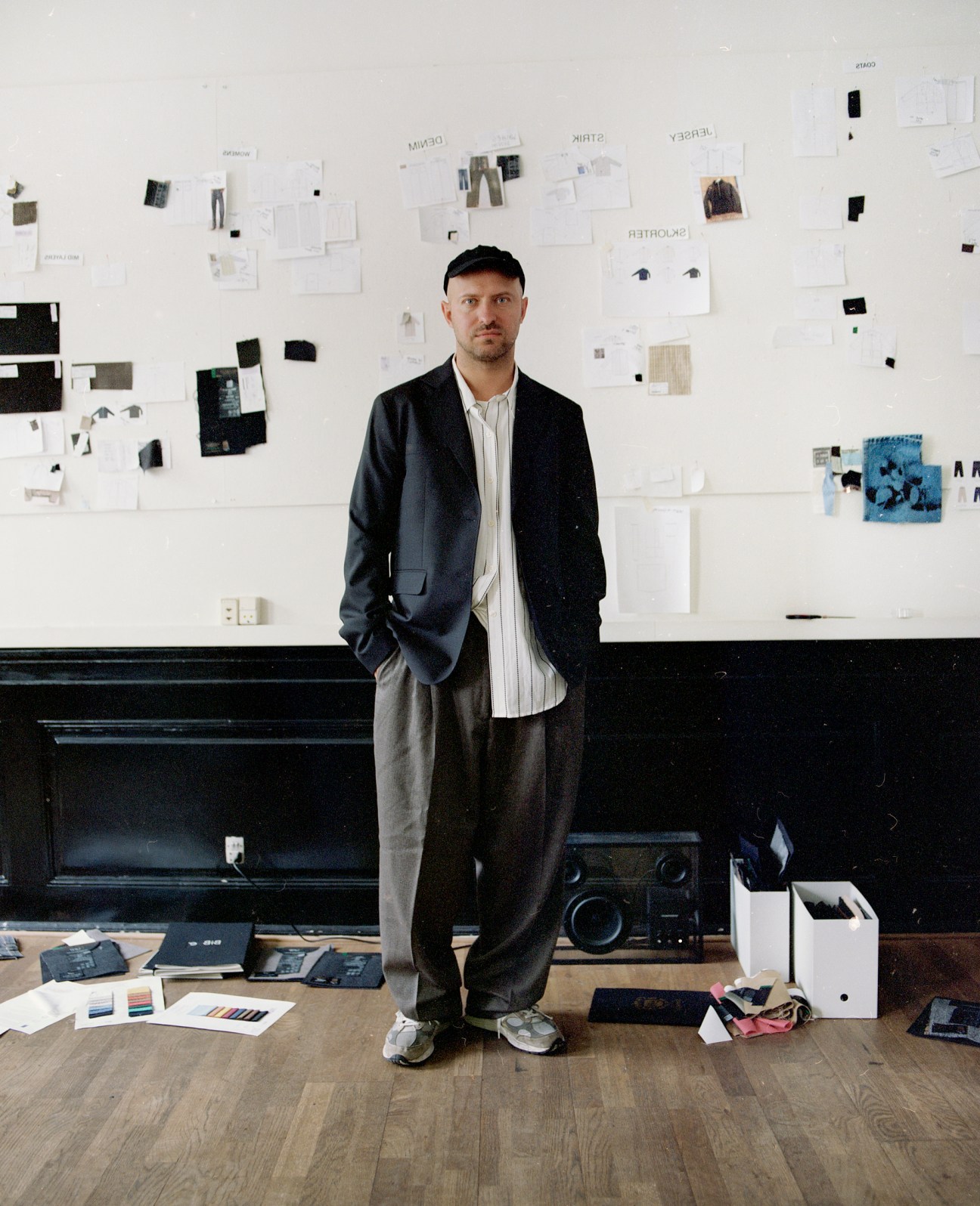 Sigurd Bank, founder of Mfpen, standing in a creative workspace with design materials and mood boards on the wall