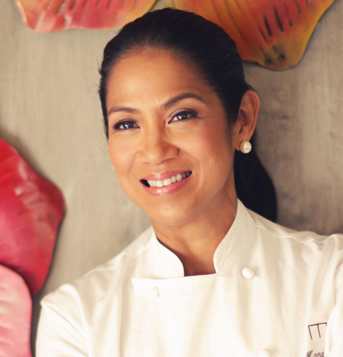 Portrait of chef Margarita Forés in her restaurant kitchen wearing chef's whites