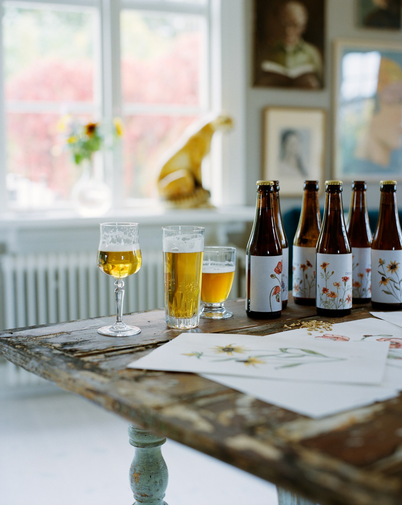 Munklägret beer bottles with elegant botanical labels featuring plants and flowers