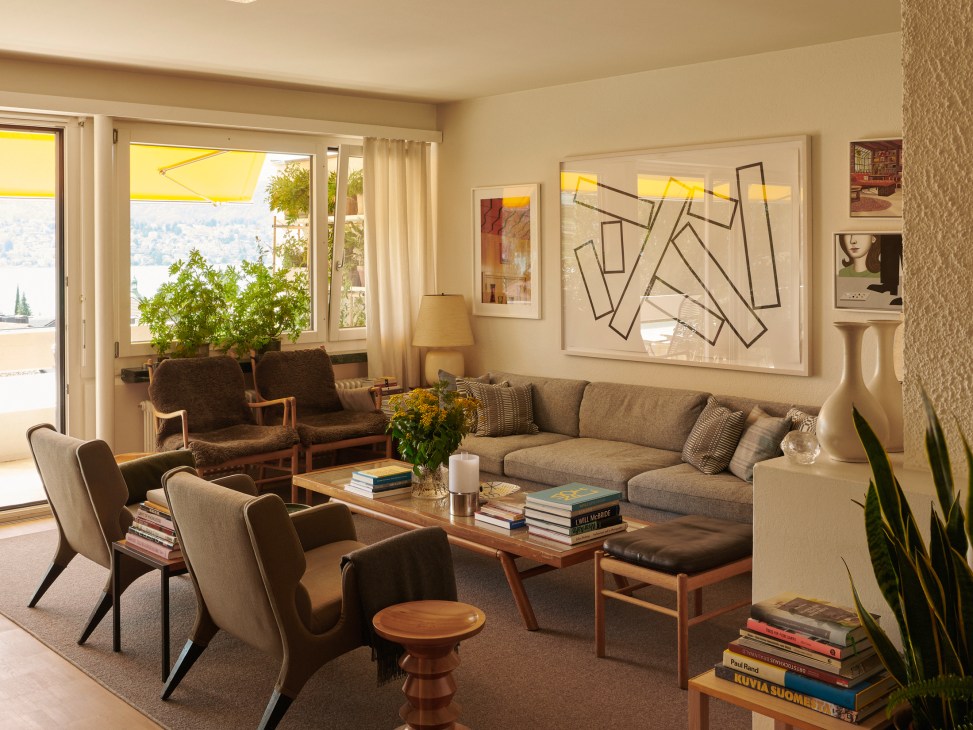 Two wooden chairs positioned by window with framed artwork on wall