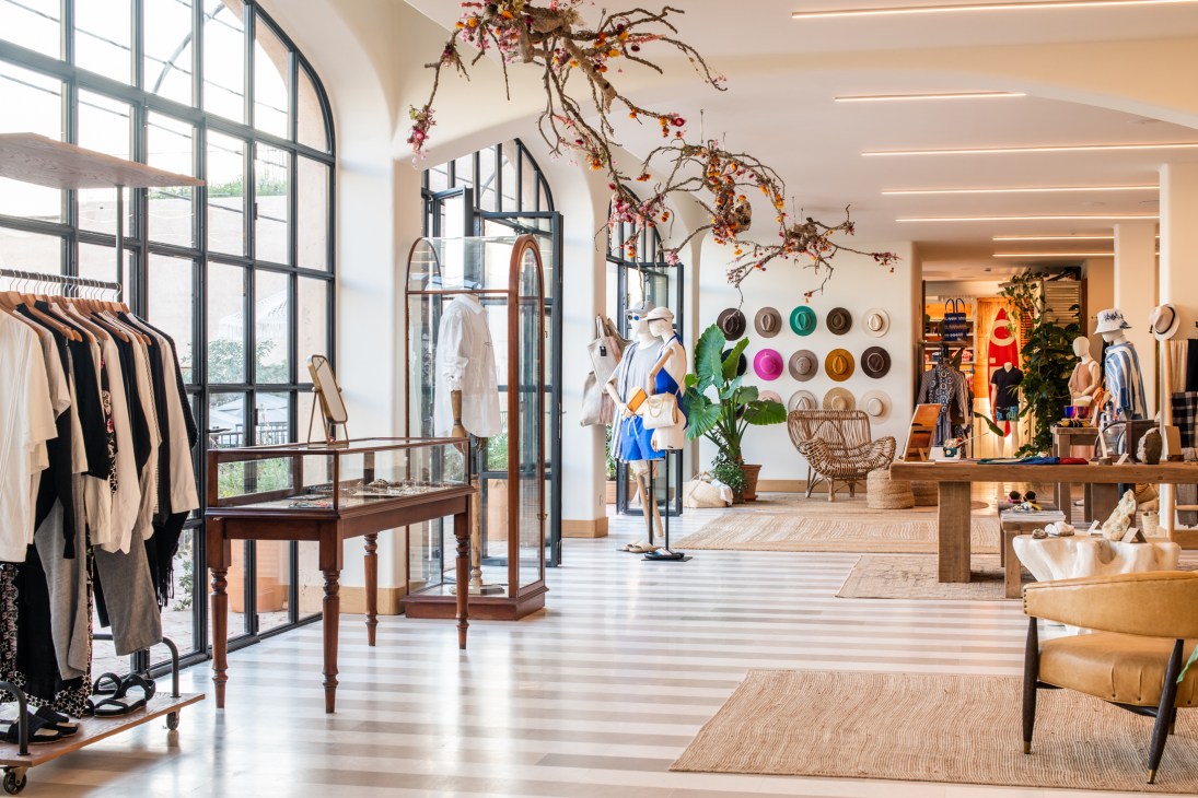 Modern retail interior with clothing displays, natural lighting, and contemporary design elements